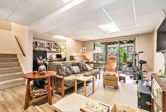 2519 Meade Ct, Ann Arbor, MI 48105 - living area featuring a paneled ceiling, wood finished floors, and stairway