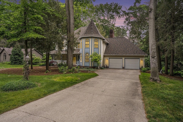 4686 Doug Dr, Whitehall, MI 49461 - view of front of house featuring a garage, driveway, a yard, a chimney, and a porch