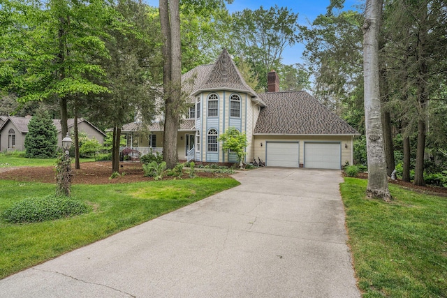 4686 Doug Dr, Whitehall, MI 49461 - victorian home with a chimney, a garage, concrete driveway, and a front lawn