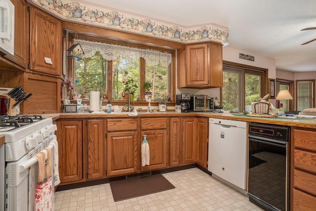 4686 Doug Dr, Whitehall, MI 49461 - kitchen with white appliances, brown cabinetry, ceiling fan, and light countertops