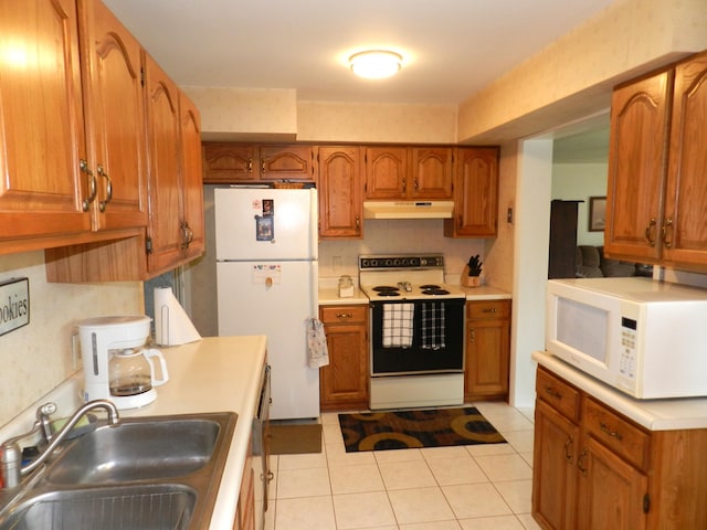 2865 Carrie Ln, Saint Joseph, MI 49085 - kitchen featuring white appliances, brown cabinets, light countertops, light tile patterned floors, and under cabinet range hood
