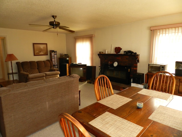 2865 Carrie Ln, Saint Joseph, MI 49085 - dining area with ceiling fan and a fireplace