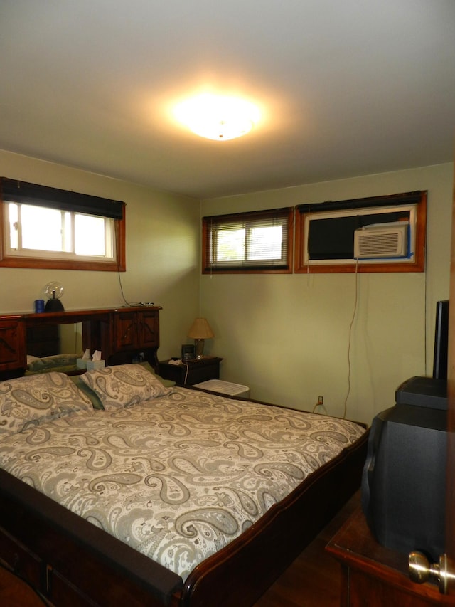 2865 Carrie Ln, Saint Joseph, MI 49085 - bedroom with a wall mounted air conditioner, multiple windows, and wood finished floors