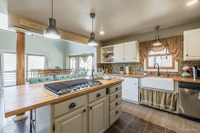 12109 Shaffer Rd, Davisburg, MI 48350 - kitchen with wooden counters, dishwasher, stainless steel gas cooktop, backsplash, and recessed lighting
