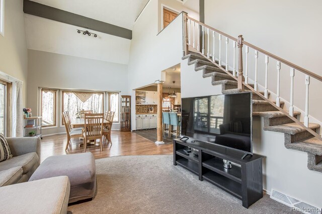 12109 Shaffer Rd, Davisburg, MI 48350 - living room with stairway, a high ceiling, and wood finished floors
