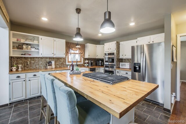 12109 Shaffer Rd, Davisburg, MI 48350 - kitchen featuring appliances with stainless steel finishes, wooden counters, white cabinets, backsplash, and recessed lighting