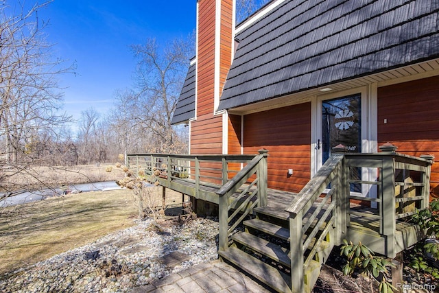 12109 Shaffer Rd, Davisburg, MI 48350 - property entrance featuring a deck and a chimney