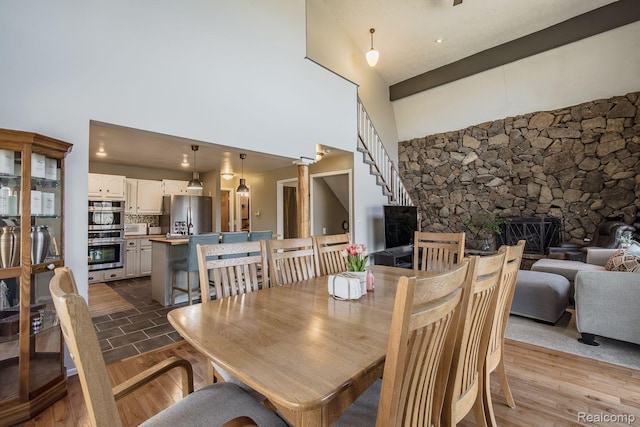 12109 Shaffer Rd, Davisburg, MI 48350 - dining room with a high ceiling, a fireplace, and wood finished floors