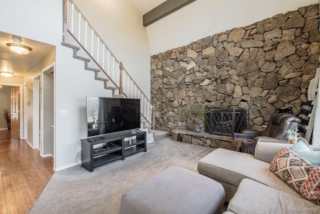 12109 Shaffer Rd, Davisburg, MI 48350 - living area with a fireplace with raised hearth, hardwood / wood-style floors, stairs, and a towering ceiling