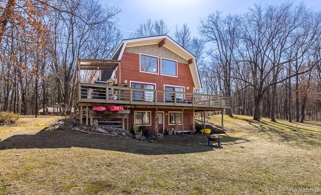 12109 Shaffer Rd, Davisburg, MI 48350 - rear view of property with a wooden deck, a gambrel roof, and a lawn