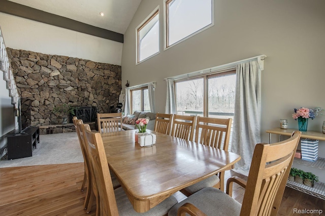 12109 Shaffer Rd, Davisburg, MI 48350 - dining space with high vaulted ceiling, wood finished floors, and a stone fireplace