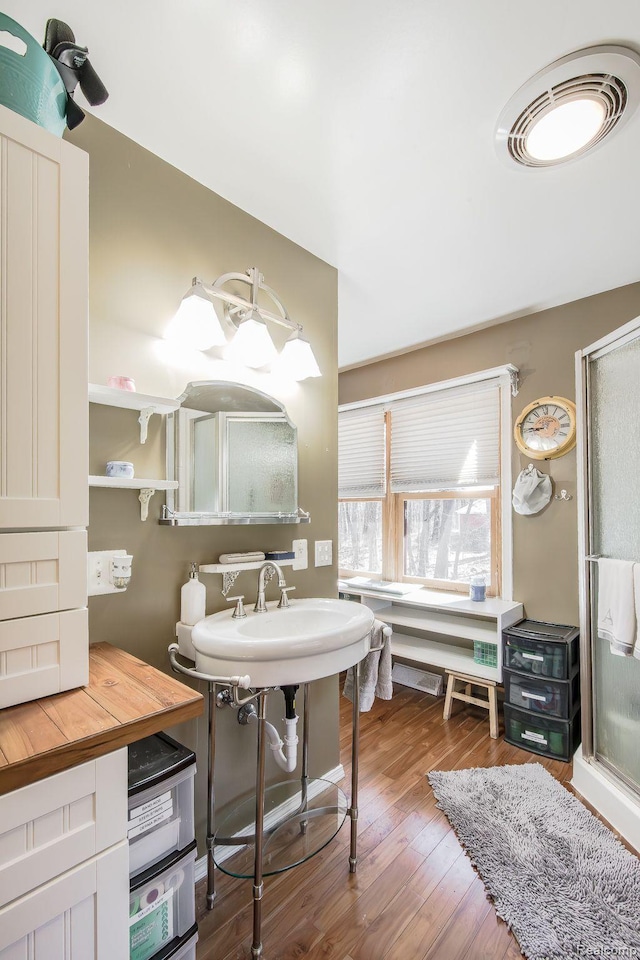 12109 Shaffer Rd, Davisburg, MI 48350 - bathroom featuring wood finished floors and a shower stall