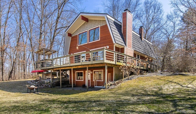 12109 Shaffer Rd, Davisburg, MI 48350 - rear view of house featuring a wooden deck, a chimney, and a lawn