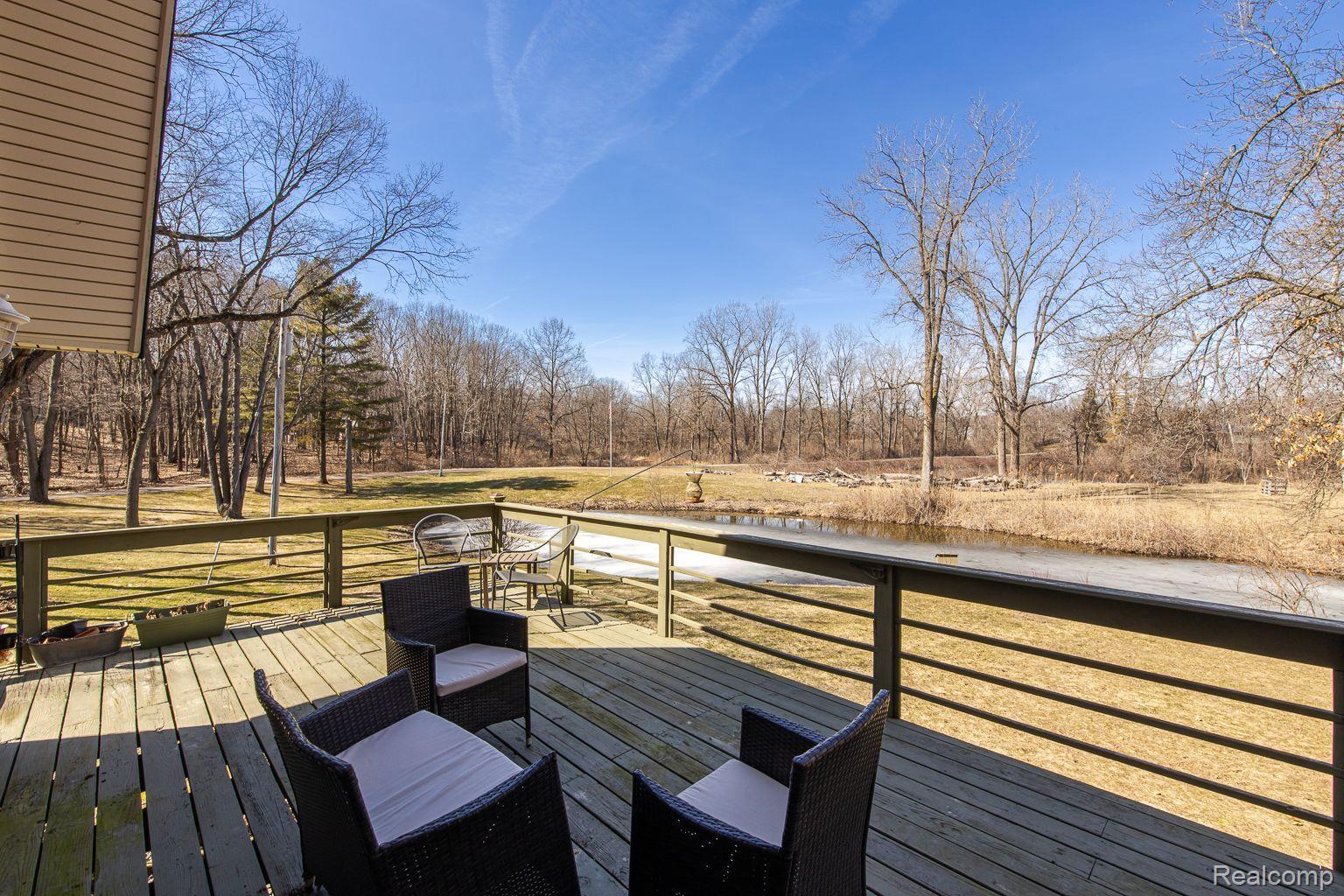 12109 Shaffer Rd, Davisburg, MI 48350 - wooden terrace featuring view of wooded area