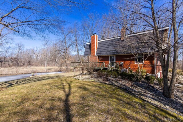 12109 Shaffer Rd, Davisburg, MI 48350 - view of green lawn with a deck with water view