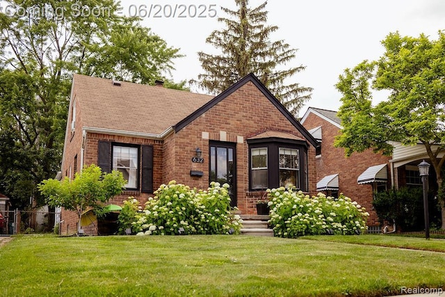 632 S Edison Ave, Royal Oak, MI 48067 - tudor house with brick siding, a chimney, and roof with shingles