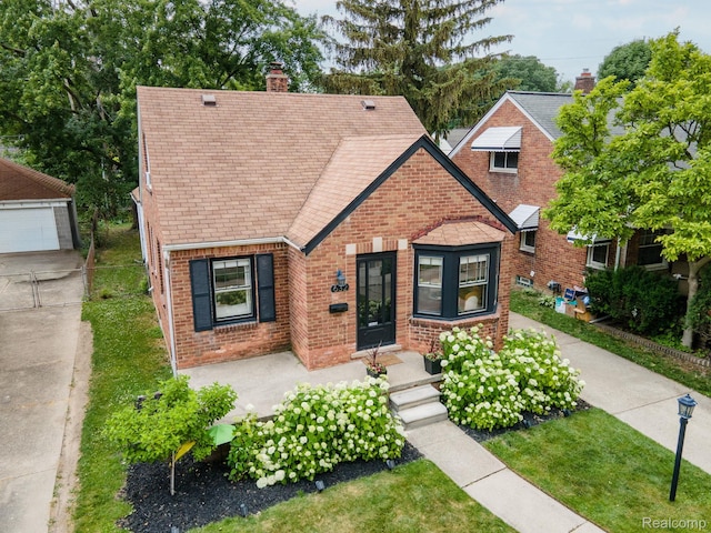 632 S Edison Ave, Royal Oak, MI 48067 - english style home with brick siding, a chimney, and roof with shingles