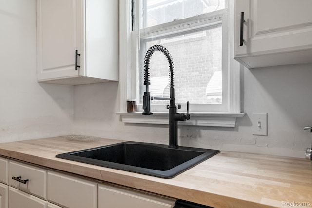 632 S Edison Ave, Royal Oak, MI 48067 - kitchen featuring wood counters and white cabinetry