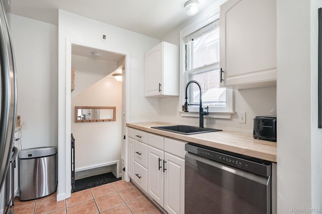 632 S Edison Ave, Royal Oak, MI 48067 - kitchen featuring appliances with stainless steel finishes, butcher block counters, white cabinetry, and light tile patterned floors