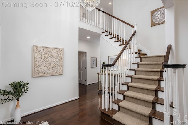 22080 Chase Dr, Novi, MI 48375 - staircase featuring wood finished floors, a towering ceiling, a chandelier, and recessed lighting