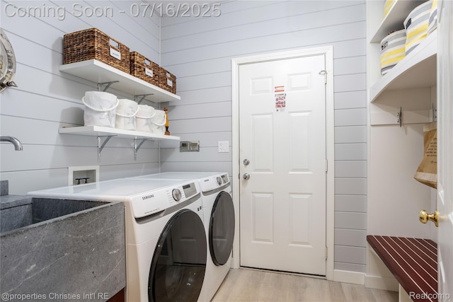 22080 Chase Dr, Novi, MI 48375 - washroom with washing machine and clothes dryer, light wood finished floors, and wooden walls