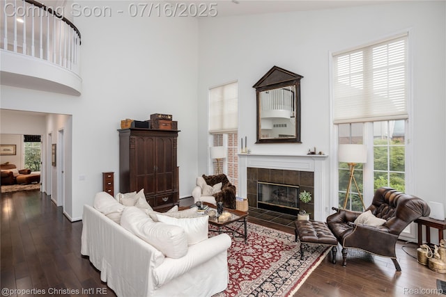 22080 Chase Dr, Novi, MI 48375 - living room with a towering ceiling, dark wood-style flooring, and a fireplace