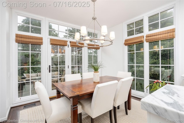 22080 Chase Dr, Novi, MI 48375 - dining space featuring a chandelier, plenty of natural light, and wood finished floors