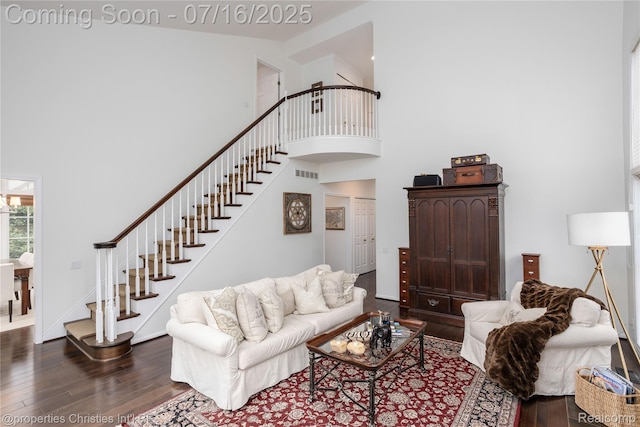 22080 Chase Dr, Novi, MI 48375 - living area featuring dark wood-type flooring, stairway, and a towering ceiling