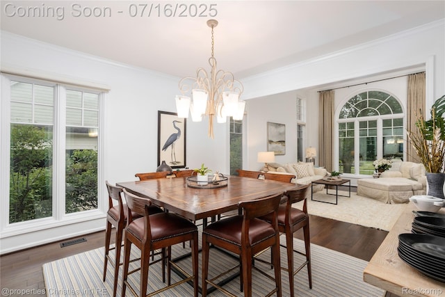 22080 Chase Dr, Novi, MI 48375 - dining space featuring crown molding, dark wood-style floors, and a chandelier