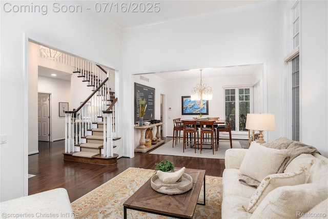 22080 Chase Dr, Novi, MI 48375 - living area with stairs, wood finished floors, a chandelier, ornamental molding, and a towering ceiling