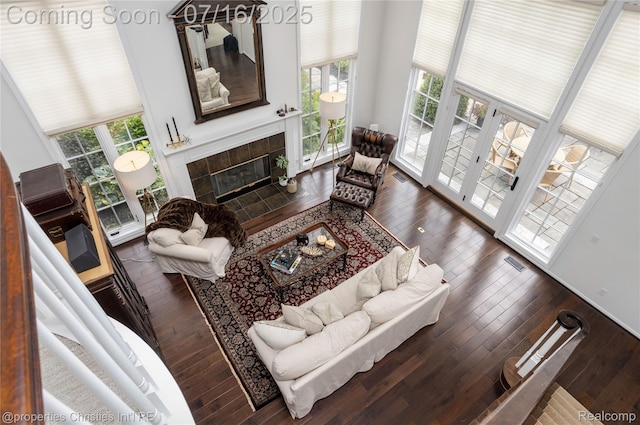 22080 Chase Dr, Novi, MI 48375 - living area featuring hardwood / wood-style flooring, a fireplace, and a high ceiling