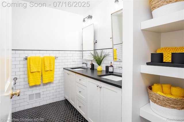 22080 Chase Dr, Novi, MI 48375 - bathroom with double vanity, tile walls, and a wainscoted wall