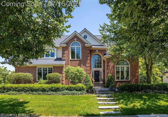 22080 Chase Dr, Novi, MI 48375 - traditional-style home featuring a front lawn, brick siding, and roof with shingles