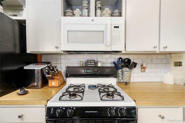 5045 Baldwin Rd, Swartz Creek, MI 48473 - kitchen featuring gas stove, white microwave, white cabinetry, tasteful backsplash, and butcher block countertops
