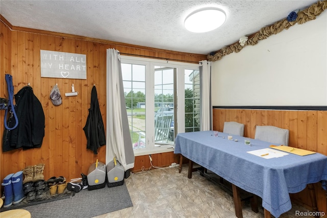 5045 Baldwin Rd, Swartz Creek, MI 48473 - bedroom featuring wood walls, multiple windows, and a textured ceiling