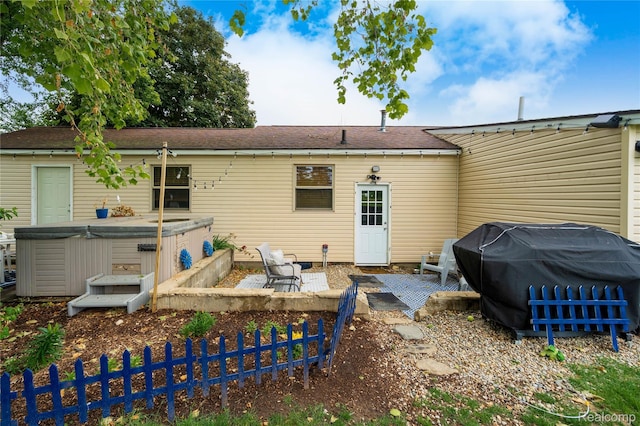 5045 Baldwin Rd, Swartz Creek, MI 48473 - back of house with a hot tub and a patio