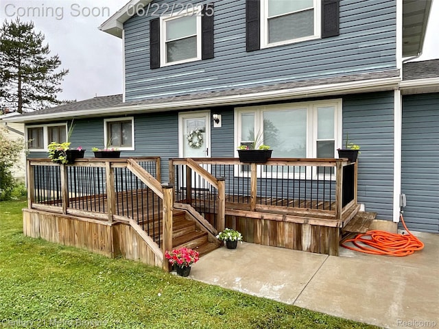 7094 Reid Rd, Swartz Creek, MI 48473 - property entrance featuring a deck, a yard, and a shingled roof