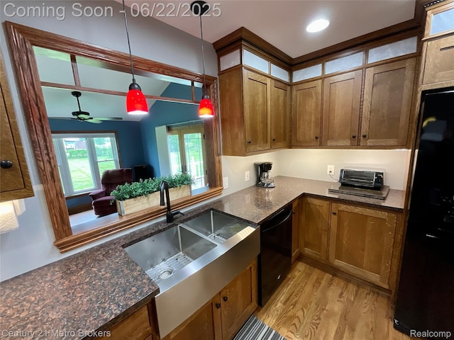 7094 Reid Rd, Swartz Creek, MI 48473 - kitchen featuring dishwasher, light wood-style floors, brown cabinetry, freestanding refrigerator, and beam ceiling