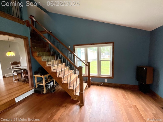 7094 Reid Rd, Swartz Creek, MI 48473 - stairway with wood finished floors and vaulted ceiling