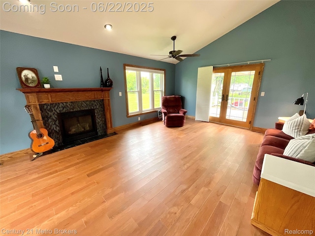 7094 Reid Rd, Swartz Creek, MI 48473 - living area featuring french doors, a high end fireplace, light wood finished floors, a ceiling fan, and high vaulted ceiling