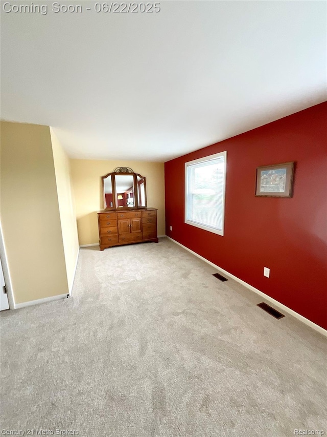 7094 Reid Rd, Swartz Creek, MI 48473 - spare room featuring carpet and baseboards