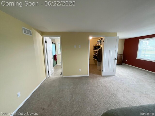 7094 Reid Rd, Swartz Creek, MI 48473 - unfurnished bedroom featuring a spacious closet, carpet flooring, and a closet