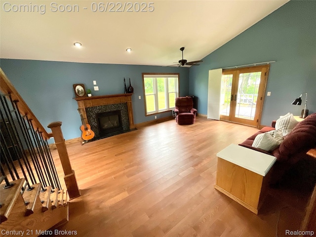 7094 Reid Rd, Swartz Creek, MI 48473 - living room with wood finished floors, vaulted ceiling, ceiling fan, a high end fireplace, and stairway