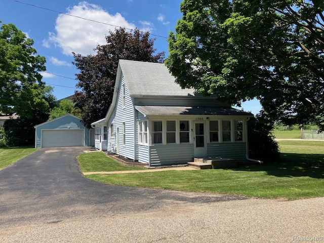 11306 W St, Grand Blanc, MI 48439 - view of front facade featuring an outbuilding, a detached garage, a shingled roof, and a front lawn