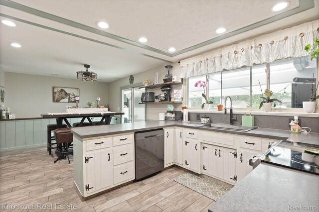 605 Shawnesee, Flushing, MI 48433 - kitchen with dishwasher, white cabinets, light wood-style floors, recessed lighting, and wainscoting