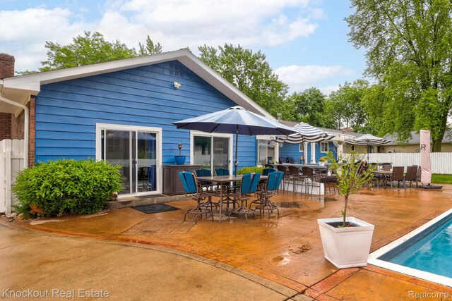 605 Shawnesee, Flushing, MI 48433 - back of house with outdoor dining area, a patio area, and a chimney
