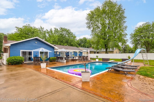 605 Shawnesee, Flushing, MI 48433 - view of pool featuring a water slide, a patio, a diving board, and outdoor dining area