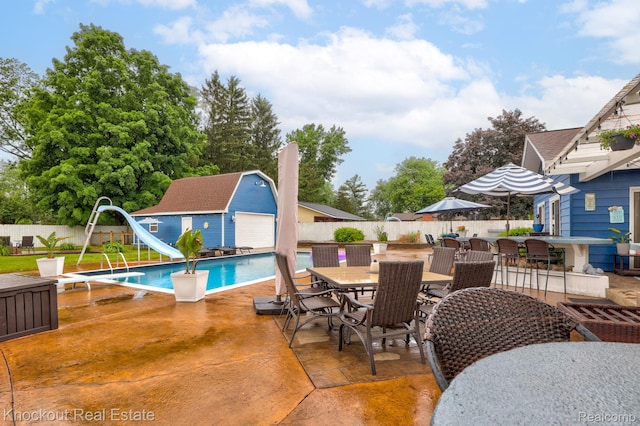 605 Shawnesee, Flushing, MI 48433 - view of pool with a water slide, outdoor dining space, a fenced backyard, and a patio