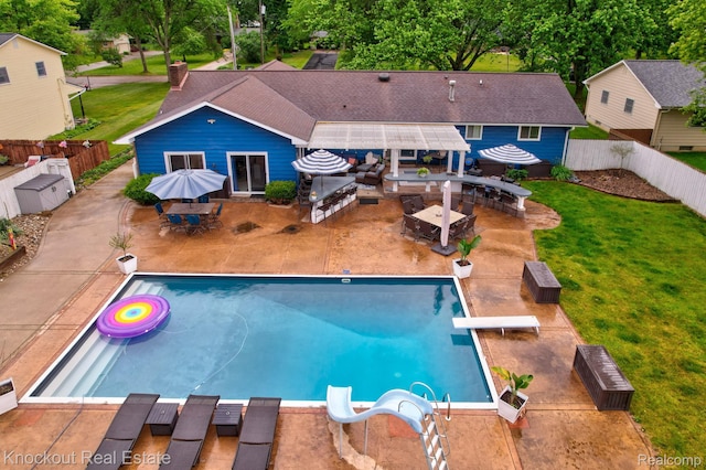 605 Shawnesee, Flushing, MI 48433 - view of swimming pool with outdoor dining area, an outdoor kitchen, a fenced backyard, and a patio