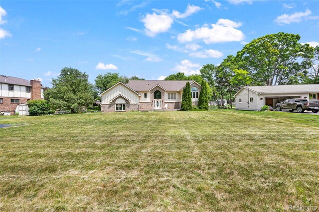 969 Bogie Lake Rd, White Lake, MI 48383 - view of front of home featuring a front yard, an outbuilding, and brick siding